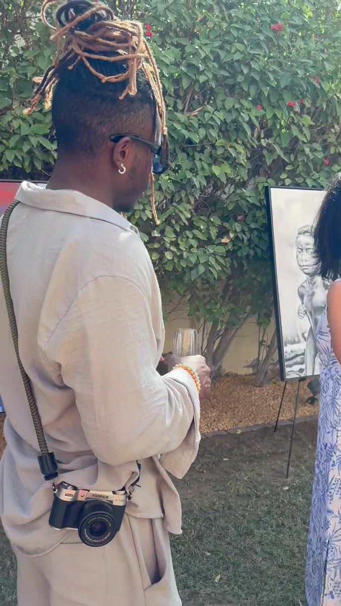 Mun Wasterfall, founder, talking a guest through a painting